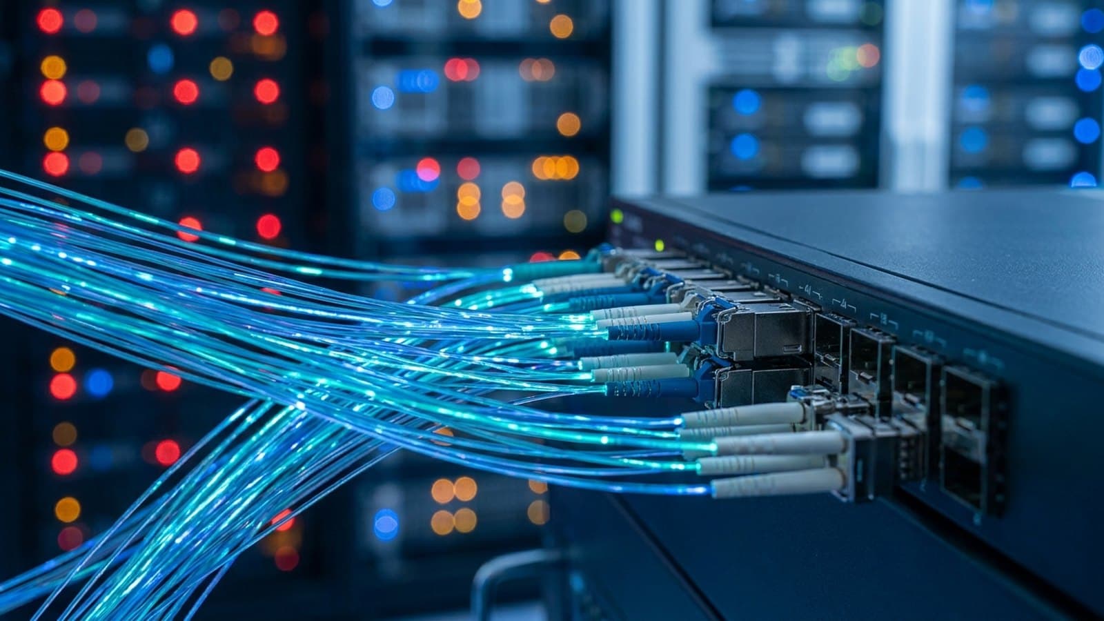 Fiber-optic strands carrying pulses of blue and teal light inside a data center, representing optical interconnects for AI compute clusters.